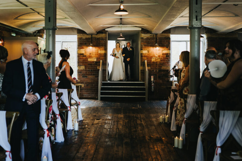 Two Brides, One Incredible Day – The Venue Bowers Mill Wedding Photography 21 Emotional moment walking down the aisle The Venue Bowers Mill wedding ceremony