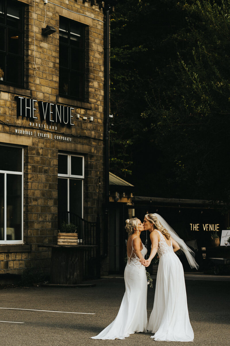 Two Brides, One Incredible Day – The Venue Bowers Mill Wedding Photography 39 Two brides holding hands walking away from The Venue Bowers Mill Halifax